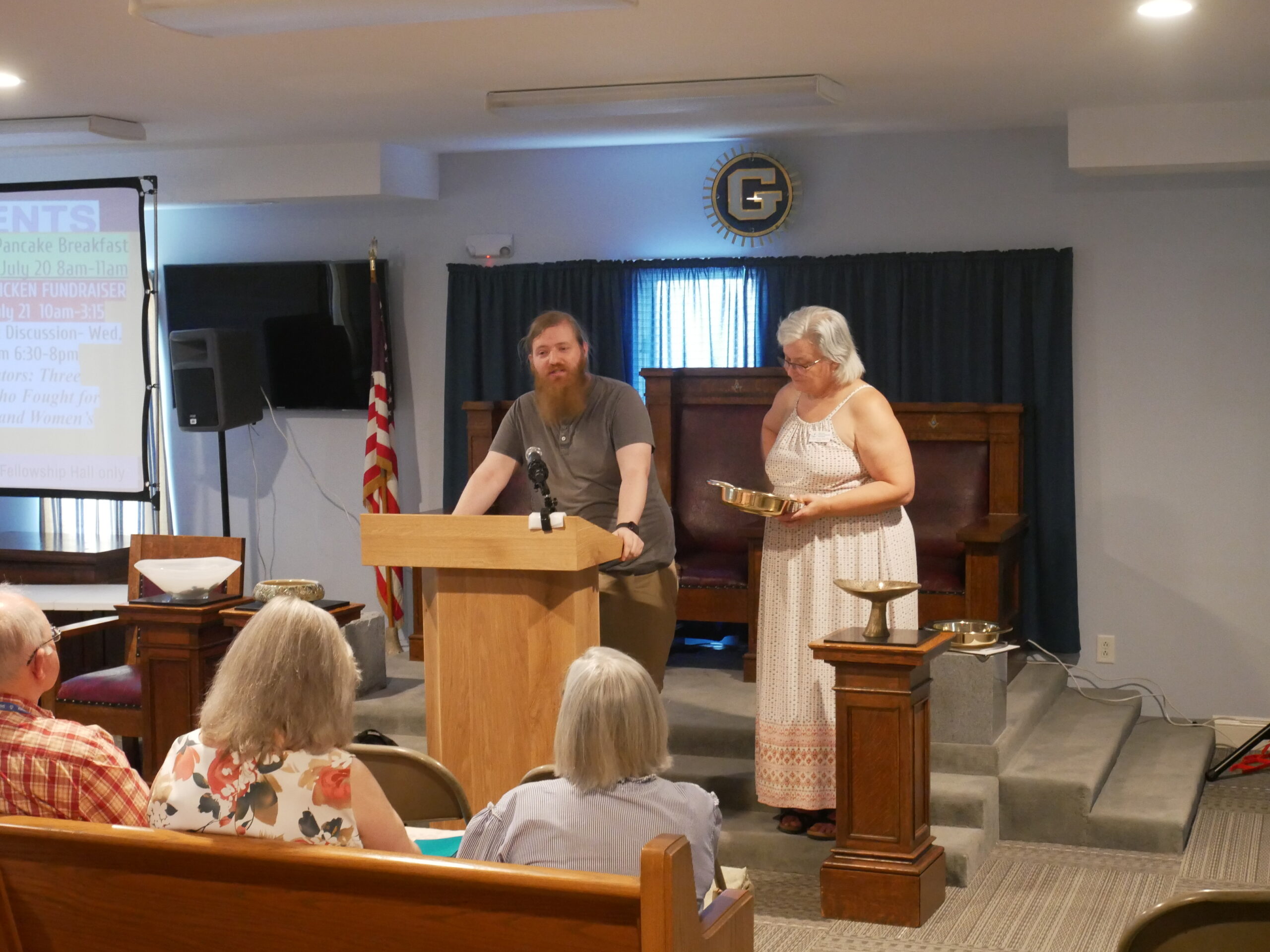 members of a church congregation speaking at a podium